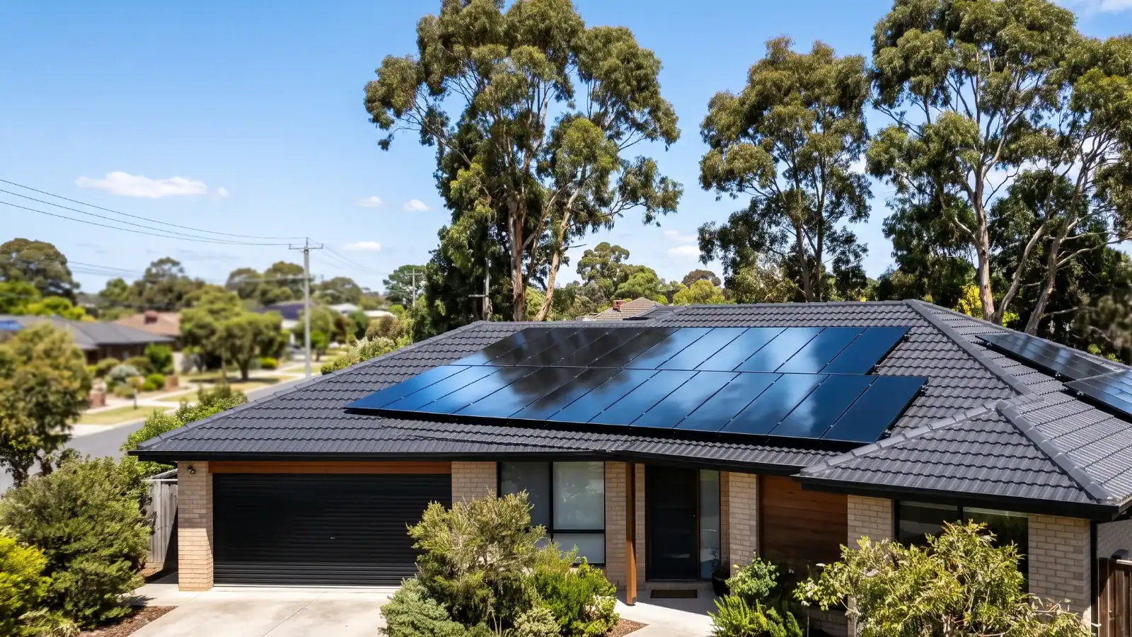 All black solar panel array installed on the tiled roof of an Australian home